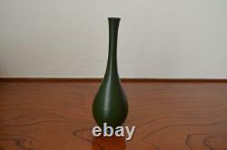 Furthermore A set of two bronze vases with a single flower
