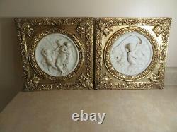 Set of Two Round Marble Like Plaques with Cherubs mounted in Ornate Gilt Frames