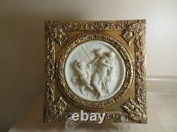 Set of Two Round Marble Like Plaques with Cherubs mounted in Ornate Gilt Frames