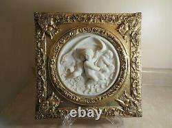 Set of Two Round Marble Like Plaques with Cherubs mounted in Ornate Gilt Frames