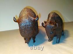 Set of two (2) carved wooden Ironwood buffalo adult and youth sculpture