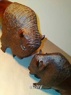 Set of two (2) carved wooden Ironwood buffalo adult and youth sculpture